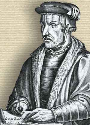 Engraving of Heinrich Cornelius Agrippa, upper body holding quill with hands on a manuscript at corner of table