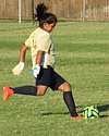 Photo of girl kicking soccer ball