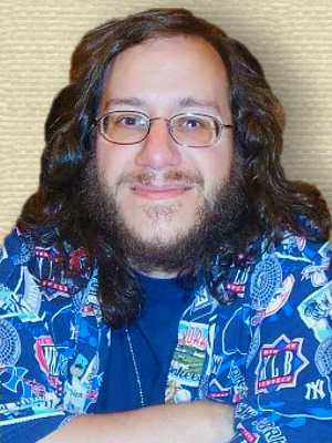 Photo of Keith DeCandido, head and shoulders, facing forward, in blue bold patterned shirt