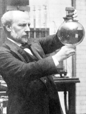 James Dewar holding a Dewar flask