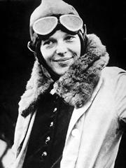 Amelia Earhart in flying jacket and googles, upper body