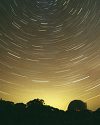 Thumbnail time-lapse photo of night sky showing light pollution at the horizon