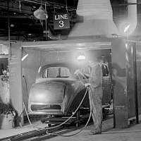Photo of factory car paint booth with worker 1945, b/w