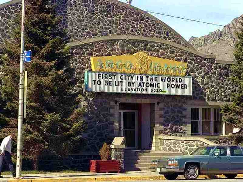 Photo of building with sign over door “Arco Idaho First City in the World to be Lit by Atomic Power Elevation 5320 feet”