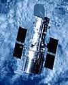 Thumbnail looking down on Hubble Telescope depicted in orbit above Earth clouds beneath as background
