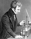 Thumbnail of engraving of Michael Faraday at lab bench with electrical experiment