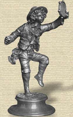 Photo Aluminum statuette on base. Boy, with hat over curly hair, vest & boots, dancing holding tambourine high, one leg in air