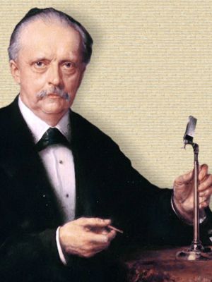 Portrait of Hermann von Helmholtz, head and shoulders, seated, facing front, with optical instrument