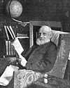 Thumbnail of Lord Kevin reading a book, seated in an armchair