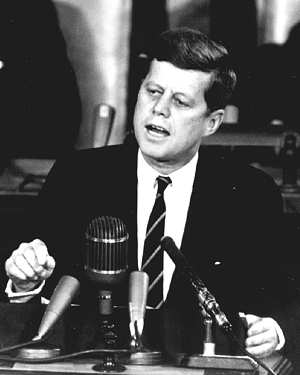 Photo of Presedent Kennedy - upper body behind lectern.