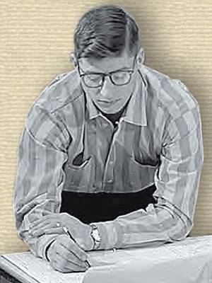 Photo of John Kobak (1962), upper body behind bench, looking down at plans, pencil in hand.