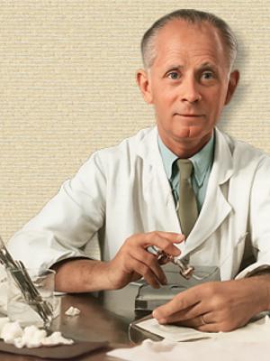 Hans Selye seated at work bench with instruments, upper body facing forward. Orig b/w colorized with sora A.I. (251019)