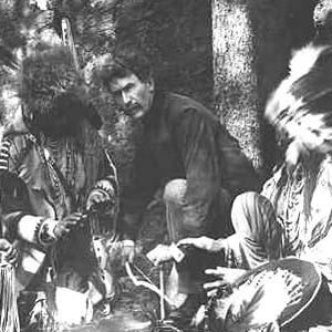 Photo of Ernest Thompson Seton with Blackfoot Indians, starting a fire with bow and stick