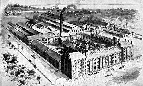 Drawing of Yale & Towne plant: Multi-story buildings covering about two city blocks. Electric trolleys run on bordering streets.